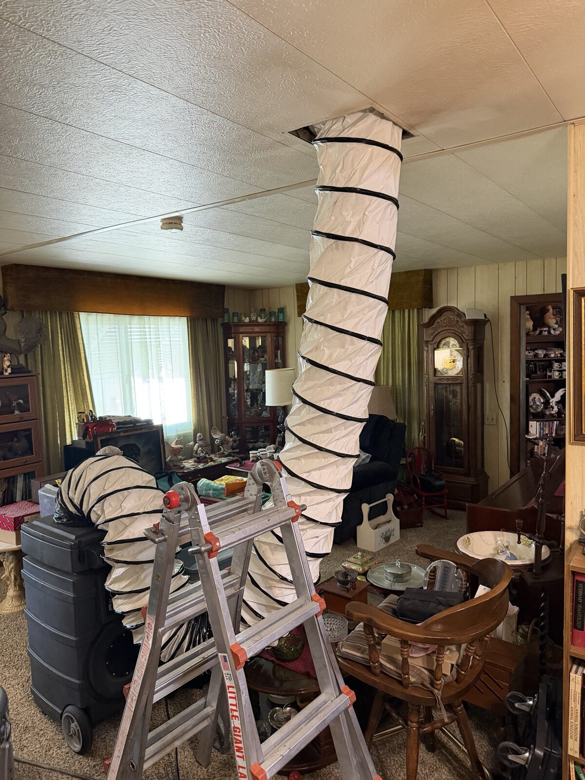 Negative-air duct cleaning in progress in a home